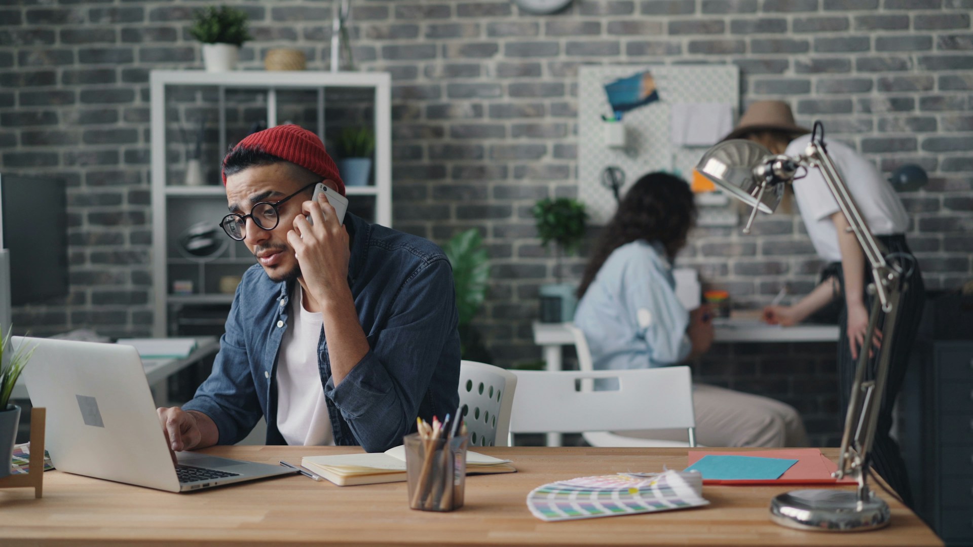 A business leader on a phone call at their desk